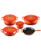Le Creuset 9-piece enameled cast iron cookware set in flame color.