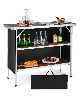 Folding silver camping table with 2 open shelves for BBQ.